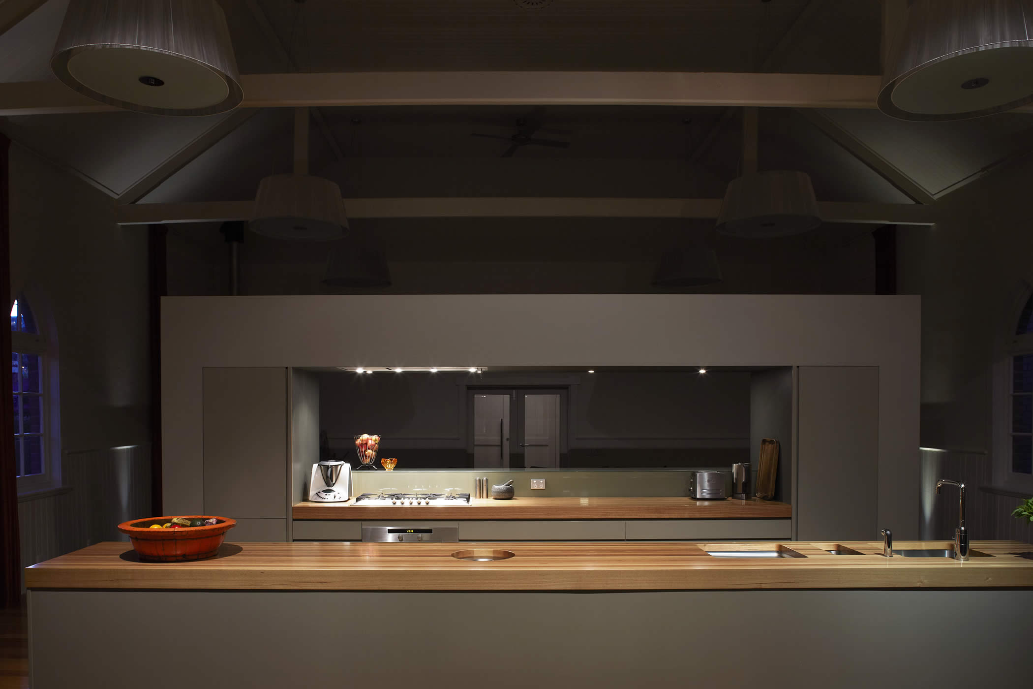 93a Hill Street, West Hobart, Tasmania: The contemporary kitchen combines restrained colour and natural hardwood timber bench tops with low energy lighting for functional illumination and dramatic impact when desired. Photo by Peter Whyte.