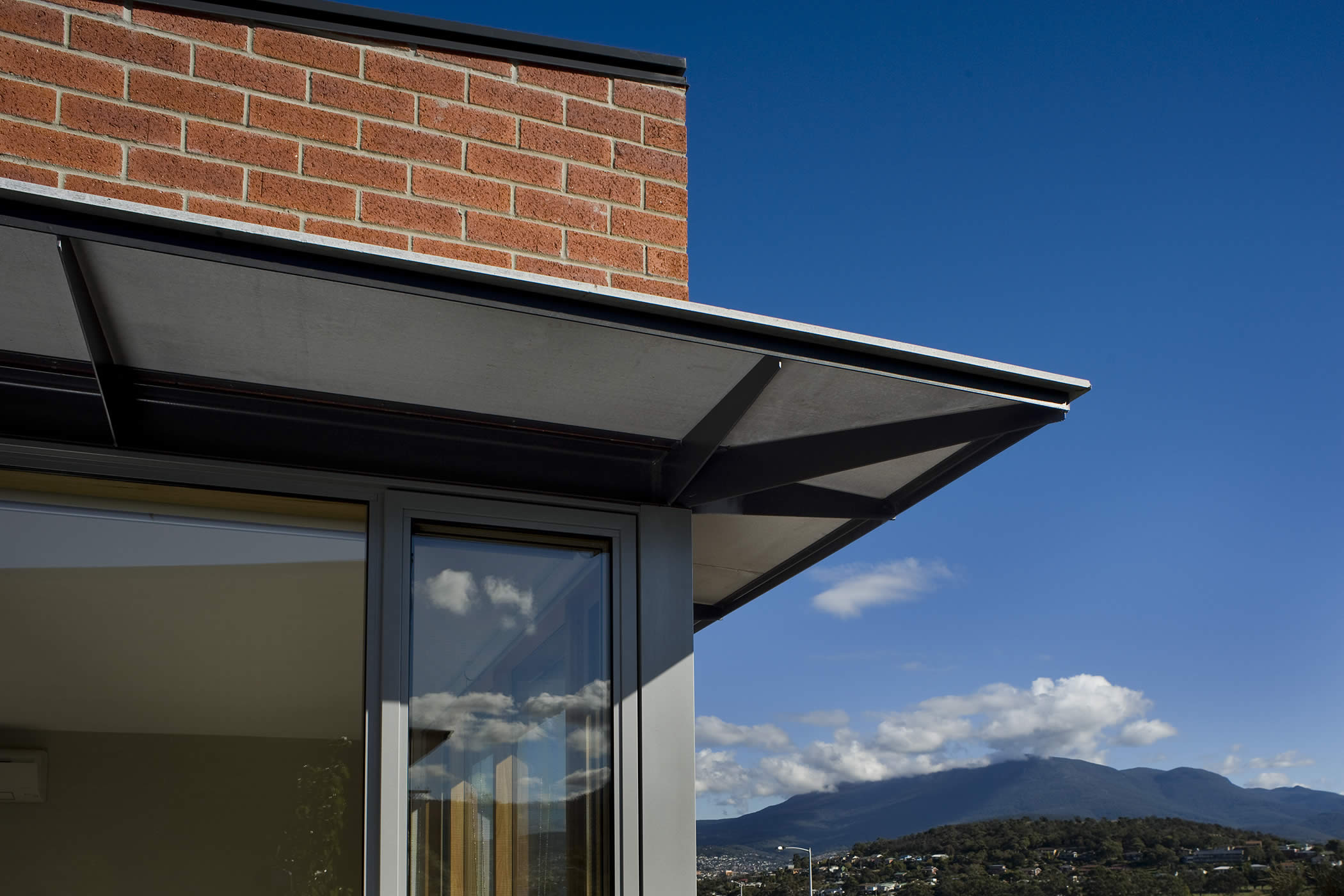 Balamara Street Housing, Bellerive, Tasmania: Passive solar design principles and architectural elements control solar gain while well placed windows capture views to kunanyi / Mount Wellington giving the scheme a sense of place. Photo by Ray Joyce.