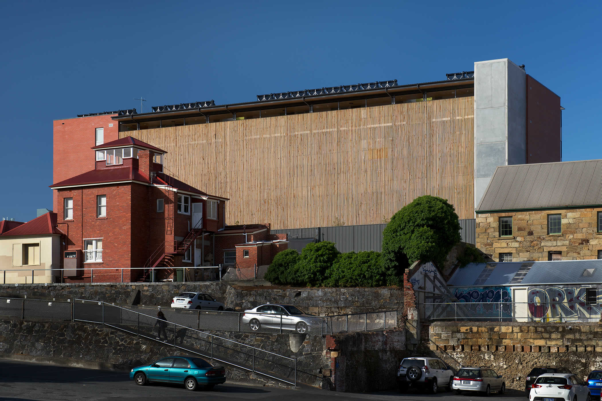 40 Brisbane Street, Hobart, Tasmania: A delicate 4 storied macrocarpa timber screen presents an uncompromising southern facade to the urban environment below and provides visual contrast to the massive concrete building ends. Photo by Ray Joyce.