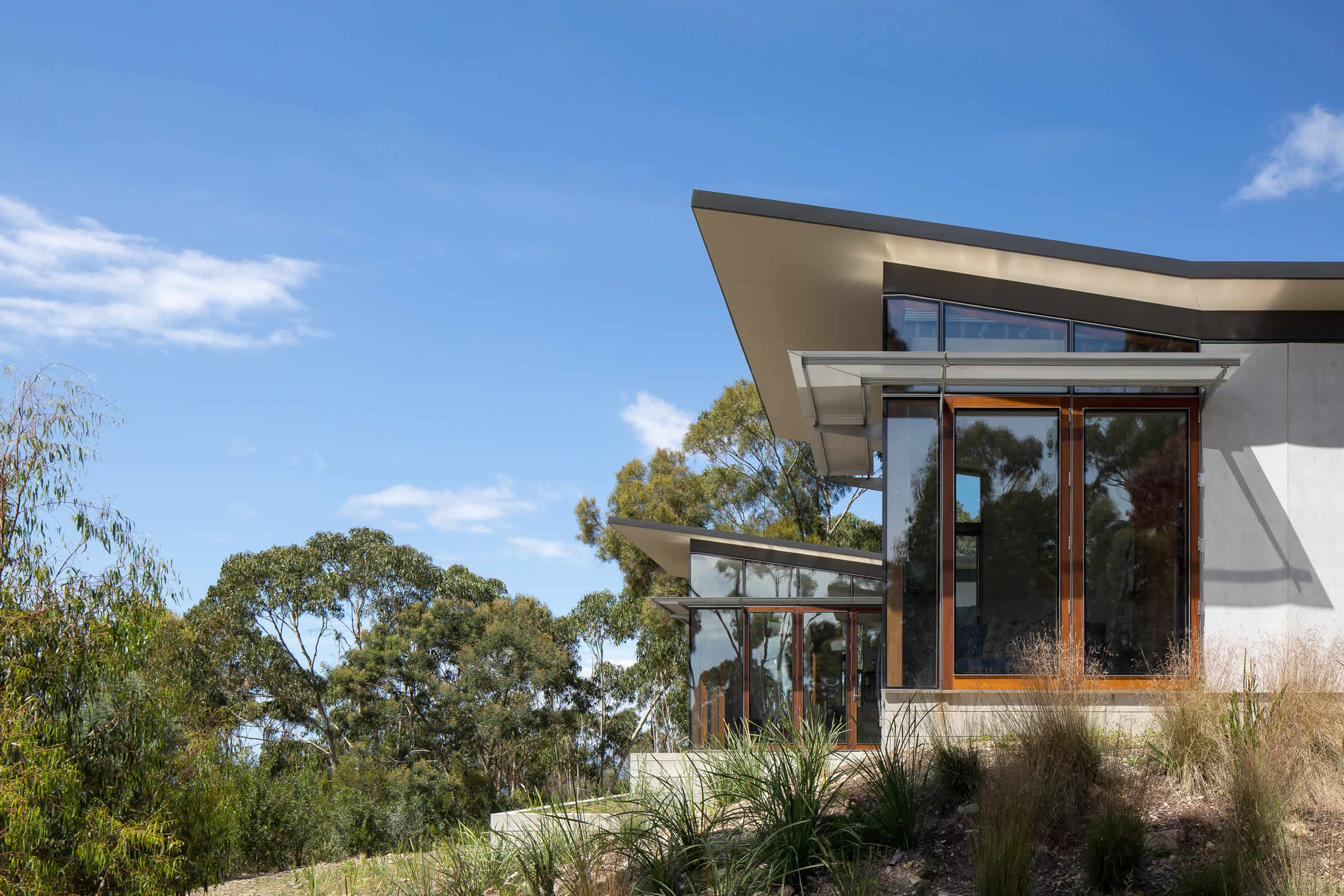 Pavilion Residence, Hobart, Tasmania: The double pavilion and courtyard home is passive solar and designed for flexible use to meet changing life-cycle needs. Energy efficient ESD includes recycled timbers and bricks.