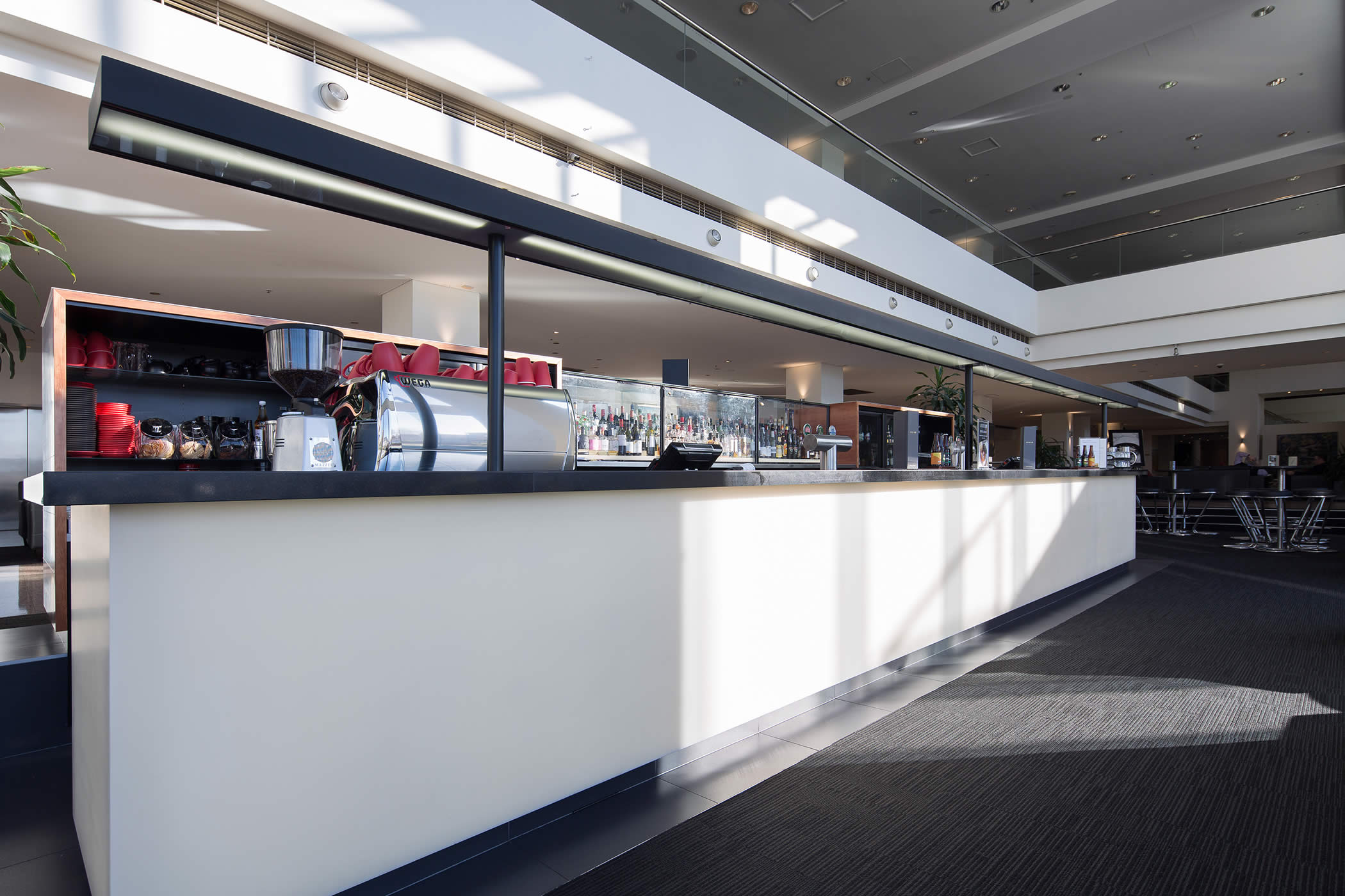 Hotel Grand Chancellor main foyer bar, Hobart: A classical but contemporary approach to materials and detail promotes the business brand and backlit panels, evocative of translucent alabaster, create added presence by night. Photo by Thomas Ryan.