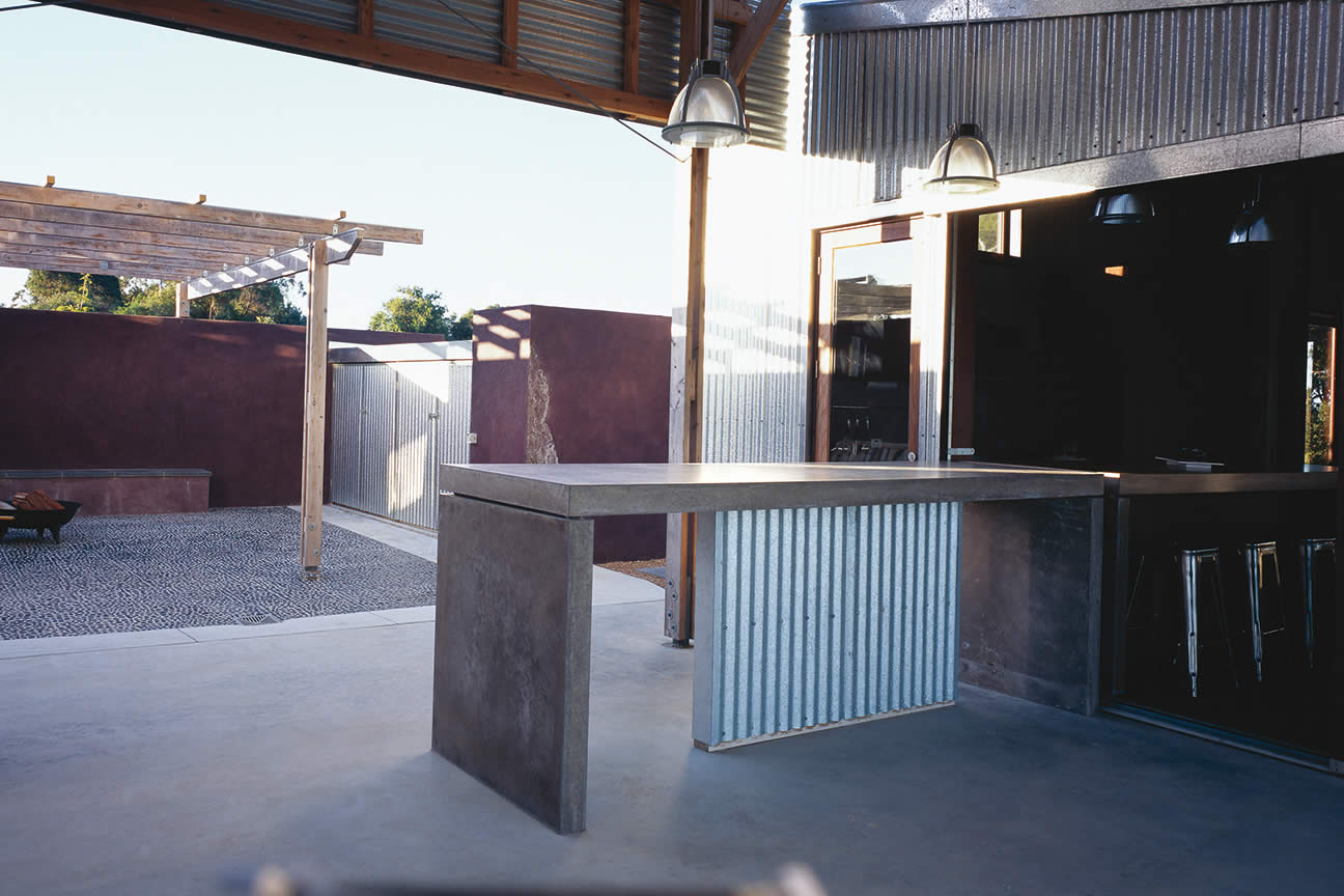 House Byrne, South Gippsland, Victoria: Outdoor courtyard spaces along the north-west include a fire-pit and materials that express the client’s love of texture, colour, contrast, and travel memories. Photo by Richard Gange.