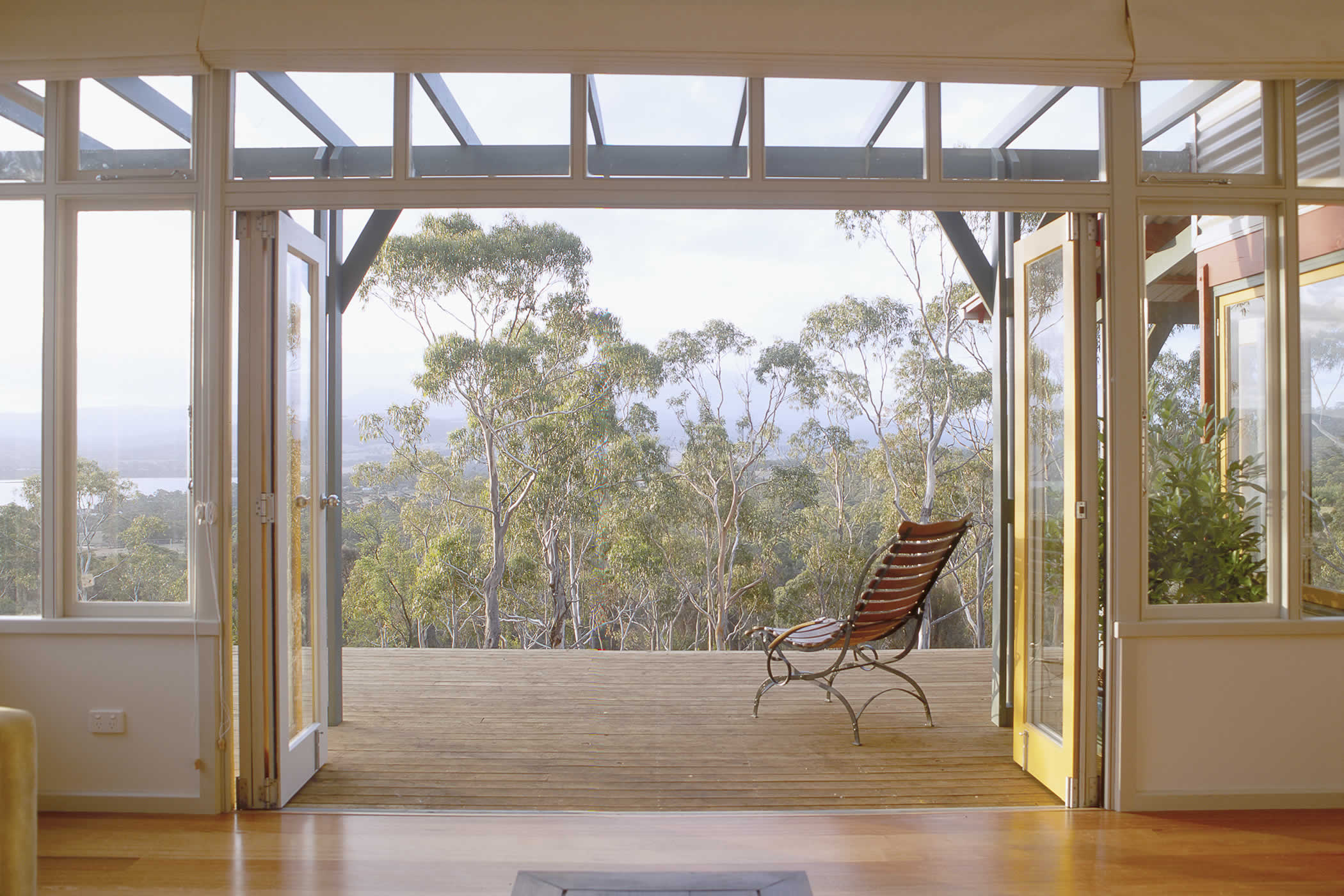 House McGregor, Tinderbox, Tasmania: An enduring image of a recliner set in a transitional zone, evokes our clients’ brief for a relaxed family lifestyle with strong connections between the interior and exterior. Photo by Peter Whyte.