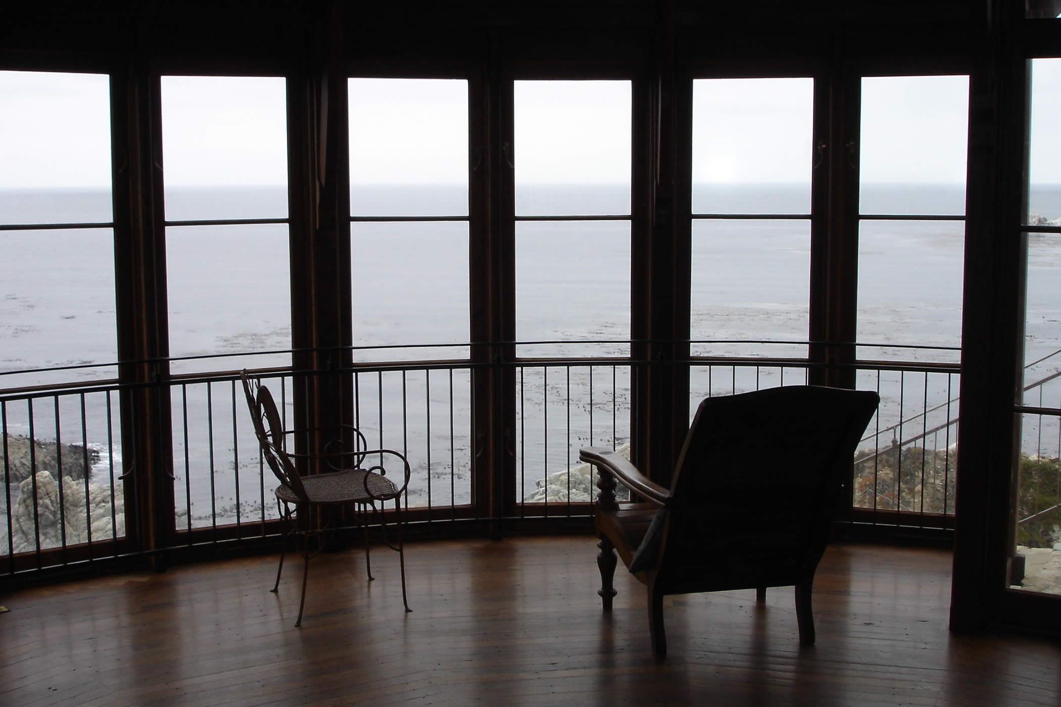 The James House Greenhouse, Carmel Highlands, California: The rotunda has a mixed eucalyptus hardwood recycled timber floor and glazed recycled timber doors which capture sweeping sea views of rich marine life and the Point Lobos State Reserve.