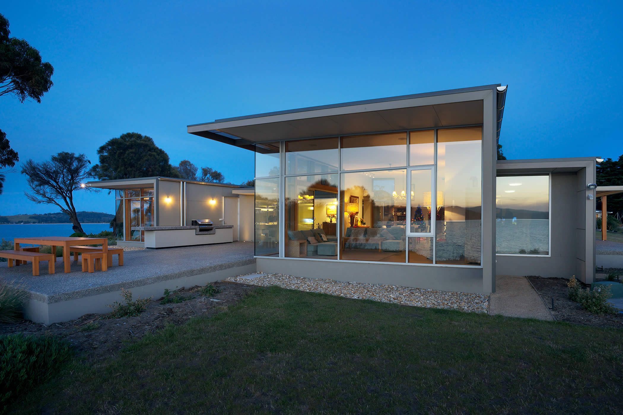 Johns Point residence, South Arm, Tasmania: Inspired by nearby finger-like peninsulas defining bays, the individual pavilions and patio "voids" capture views yet express and separate different functions and levels of privacy. Photo by Ray Joyce.