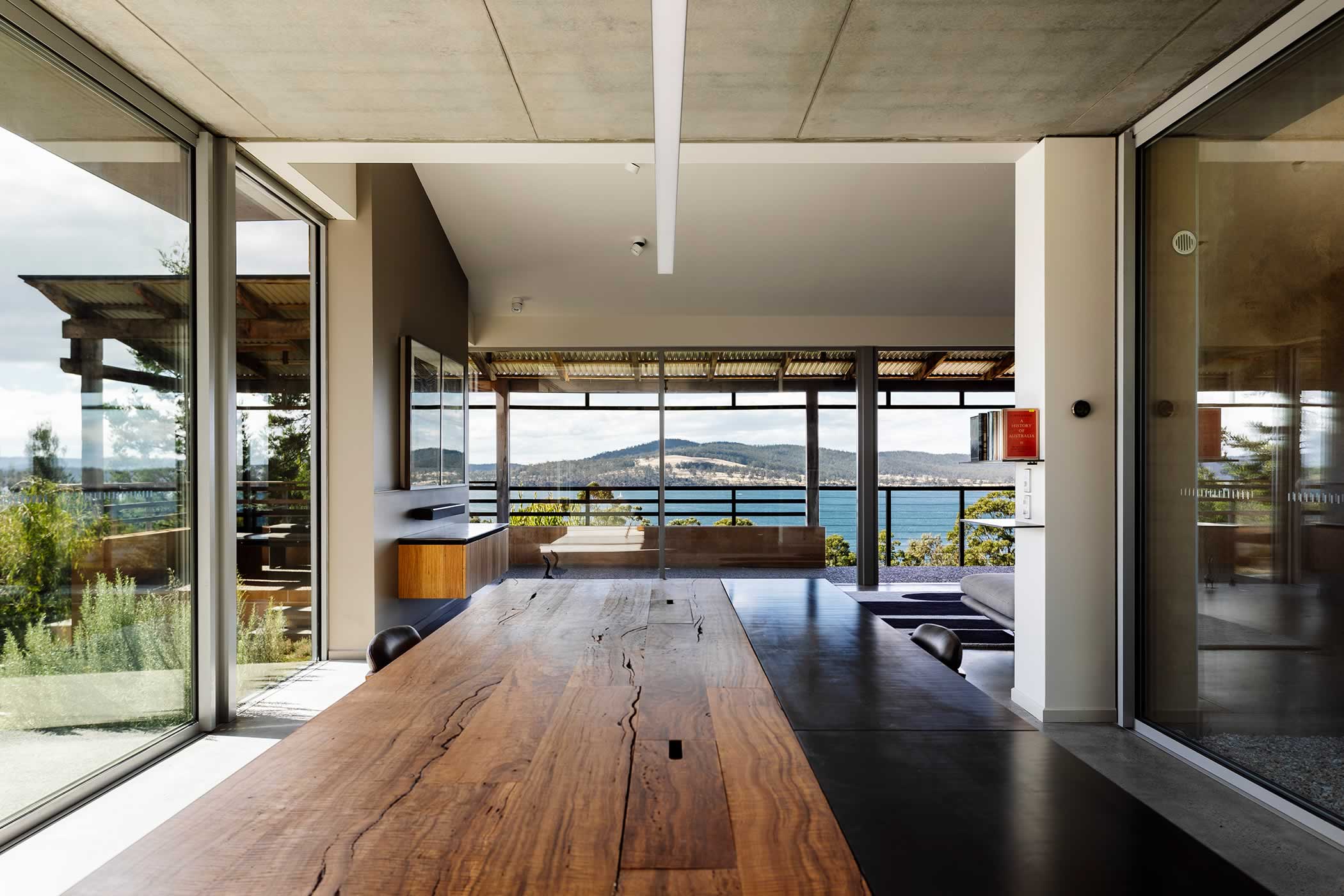 Residential extension, Kettering, Tasmania: The studio links through the extended lounge linking to an expansive Tasmanian landscape of horizontally layered water, hills and sky. Photo by Andrew Gibson. Photo by Adam Gibson.
