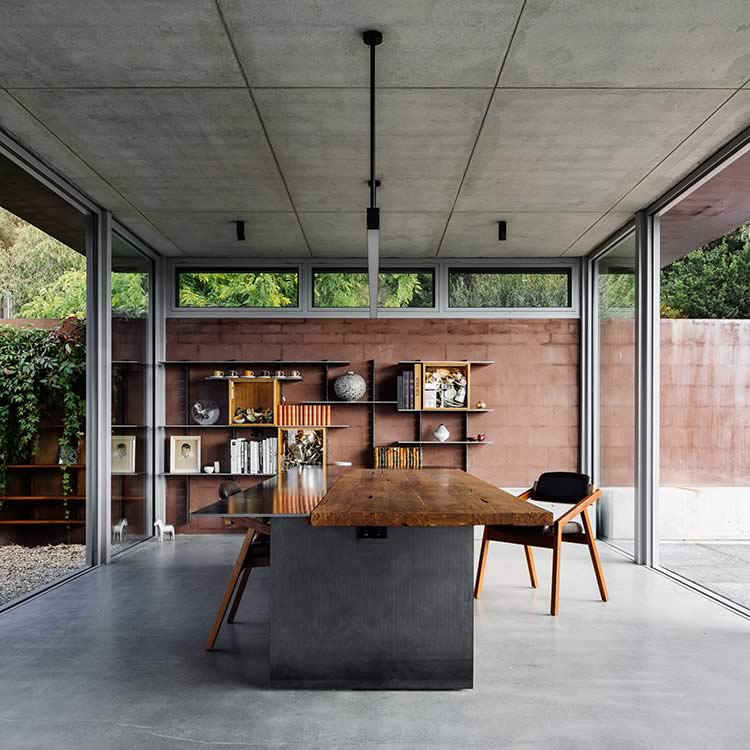 Residential extension, Kettering, Tasmania: Off-shutter concrete “floats” above a light expansive studio below. Glazing brings the outside in and inside out. The plan closes the courtyard and is orientated for natural warmth and light.