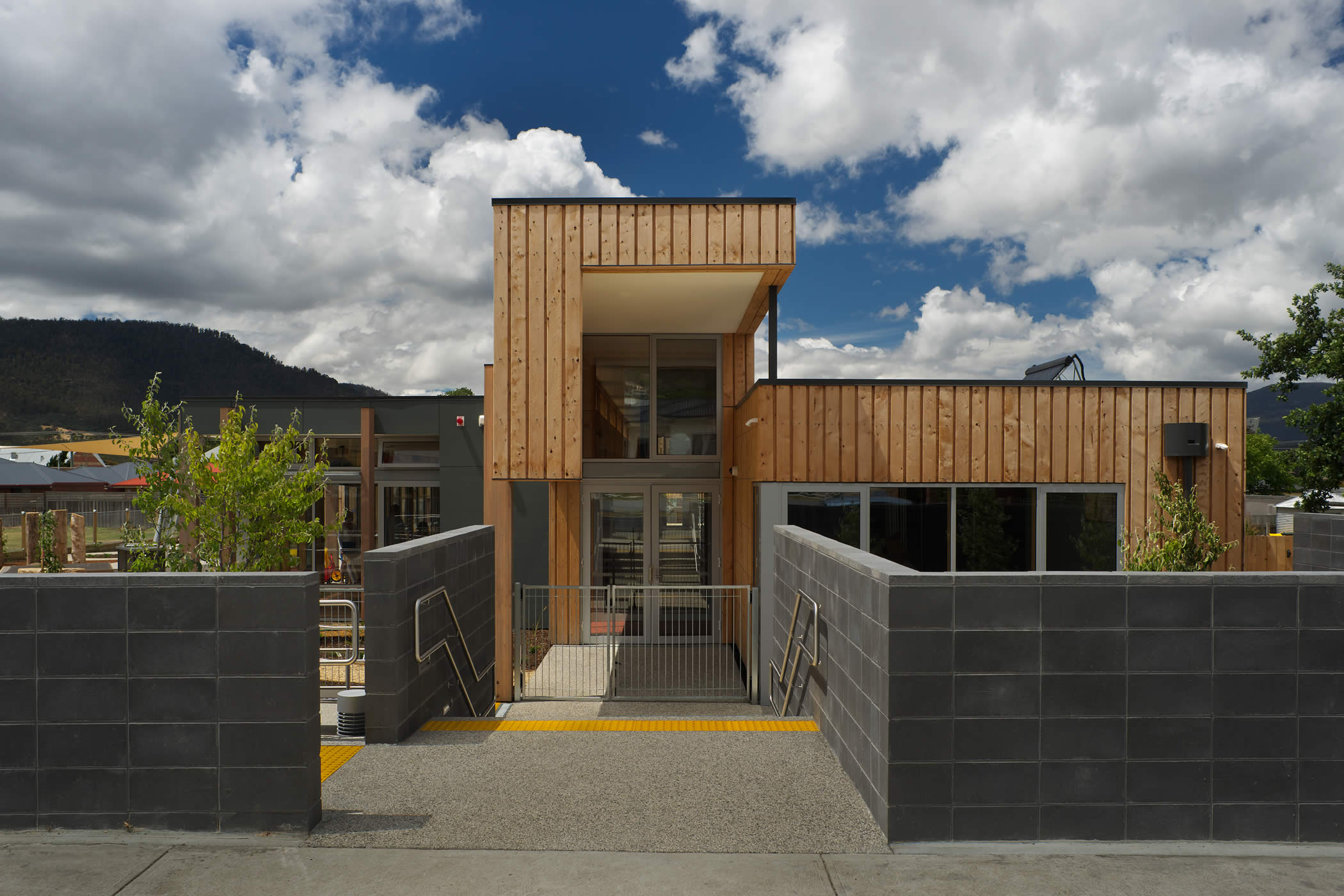 Ptunarra Child and Family Centre (CFC), New Norfolk, Tasmania: The arrival facade expresses the play mezzanine which runs the building length, with learning areas to the north and community service rooms to the south. Photo by Ray Joyce.