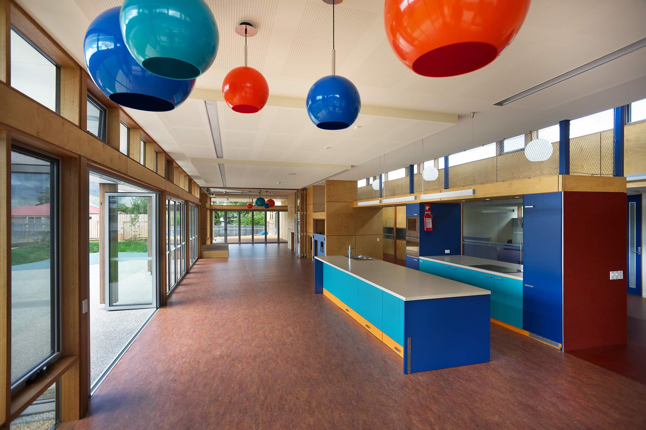 Ptunarra Child and Family Centre, New Norfolk, Tasmania: uncluttered, flexible floor space opens into northerly outdoor play areas and daylight, natural timber, and lively colour, create a welcoming, fresh and healthy atmosphere. Photo by Ray Joyce.