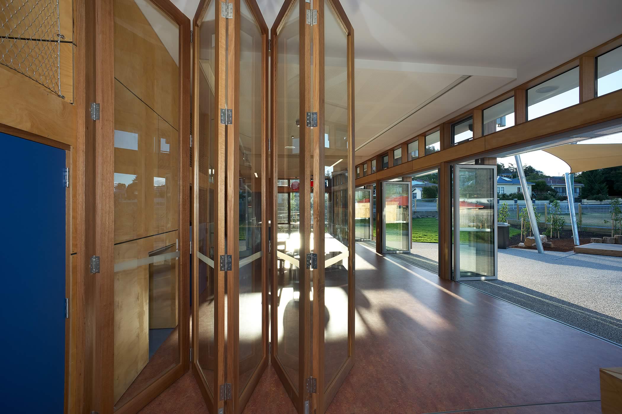 Ptunarra Child and Family Centre, New Norfolk, Tasmania: Gazed bi-fold doors divide or link flexible interior learning space, allow their expansion into northern external play areas and bring the outside in.  Photo by Ray Joyce.