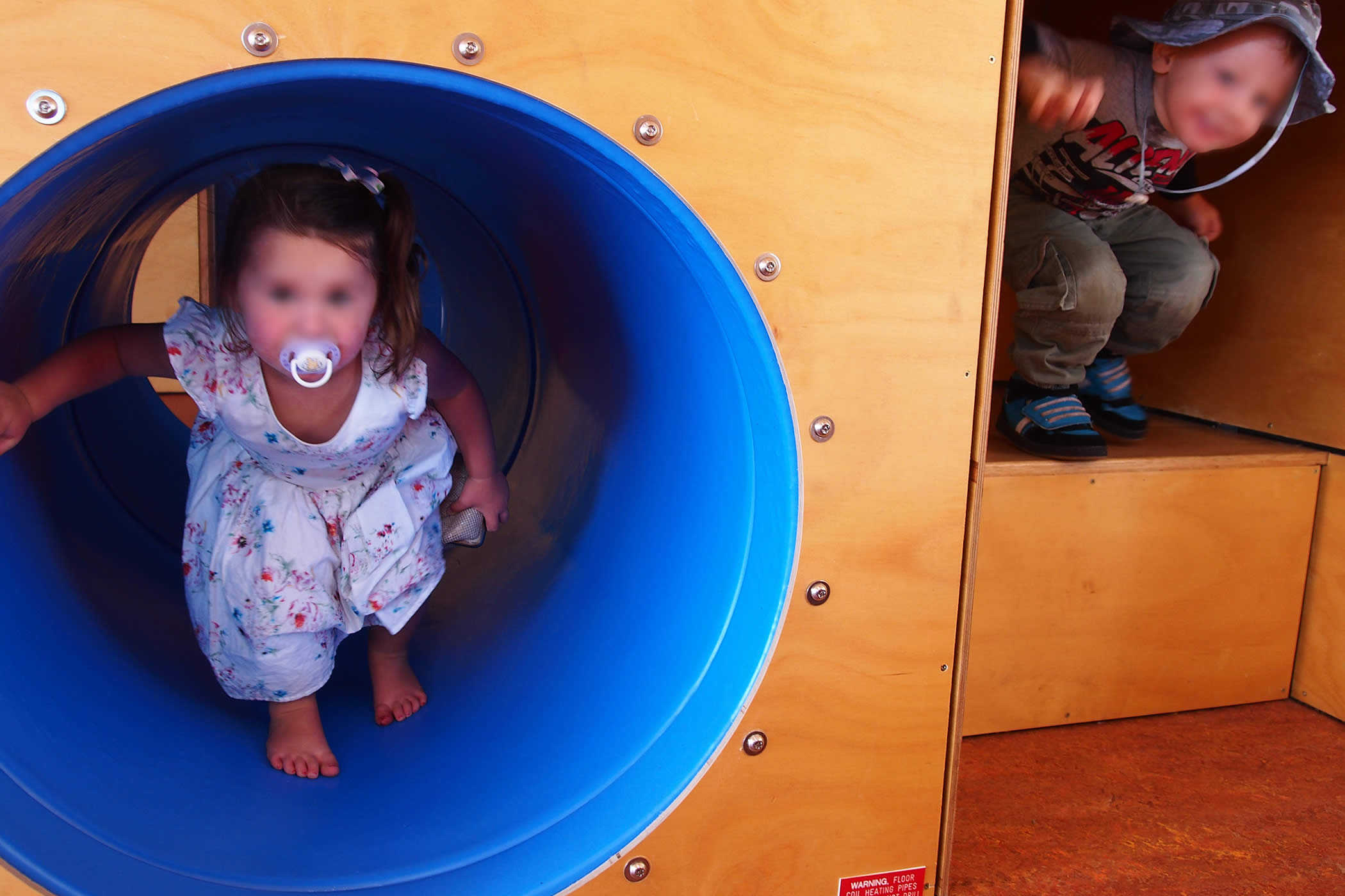 Ptunarra Child and Family Centre, New Norfolk, Tasmania: The play spine includes cubbies, nooks, sleeping nests, tunnels, and climbing steps that punctuate gross motor learning with hiding, climbing and sliding fun.  Photo by Yvette Breytenbach.