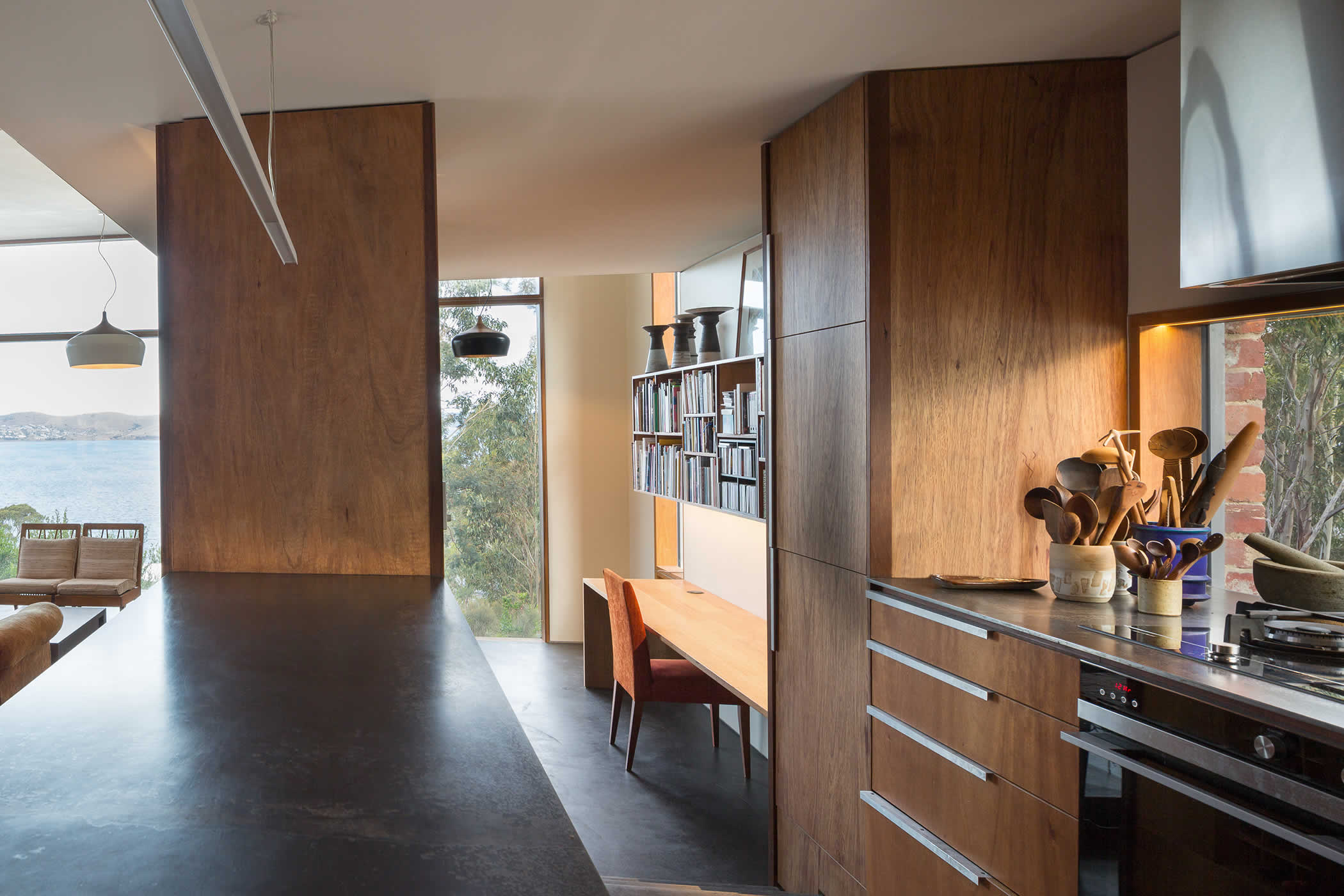 Sandy Bay, Tasmania: The main pavilion opens to the courtyards and different views. Floor and ceiling levels, alcoves and clever storage define interlinked dining, living, study, kitchen and pantry / laundry space. Photo by Thomas Ryan.