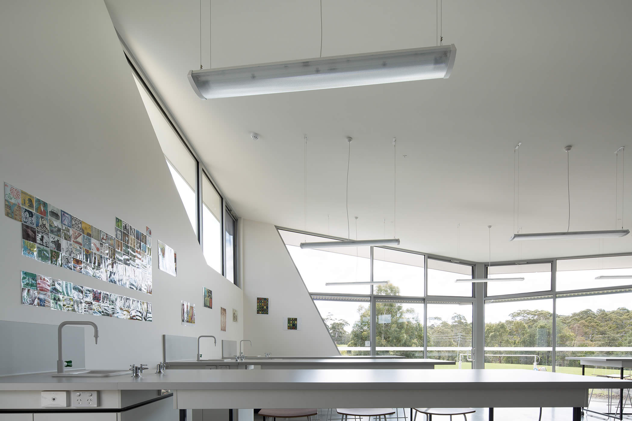 Tarremah Steiner High, Kingston, Tasmania: Angular geometries, outward views, spacious neutral interiors, daylight, and custom designed furniture create a functional, flexible, uplifting art–science learning environment.  Photo by Thomas Ryan.