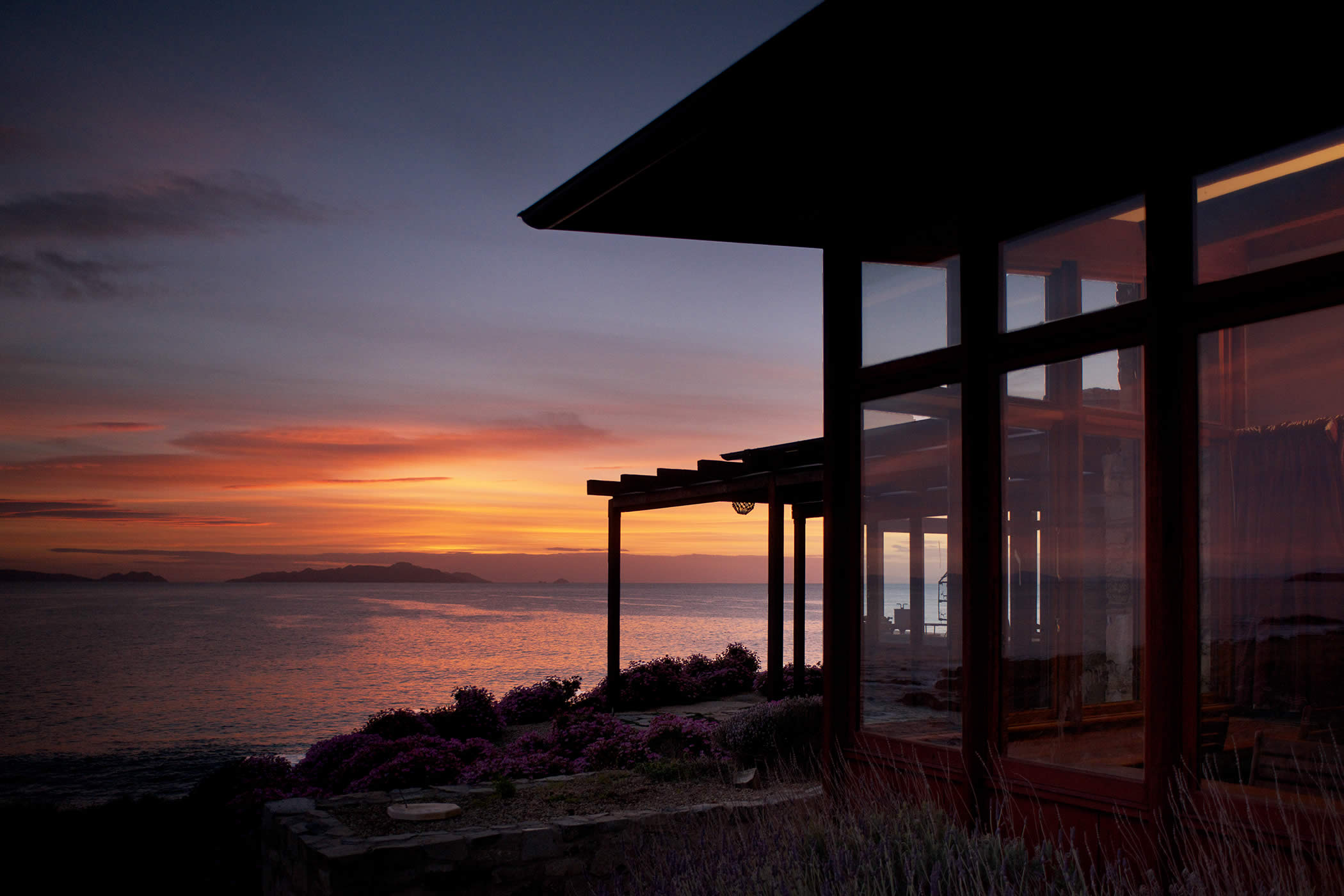 Thalia Haven, east coast Tasmania: Sunrise over spectacular sea views adds to an unforgettable, romantic, luxury experience in the remote, off-the-grid, stone and recycled timber holiday accommodation. Photo by Ray Joyce.