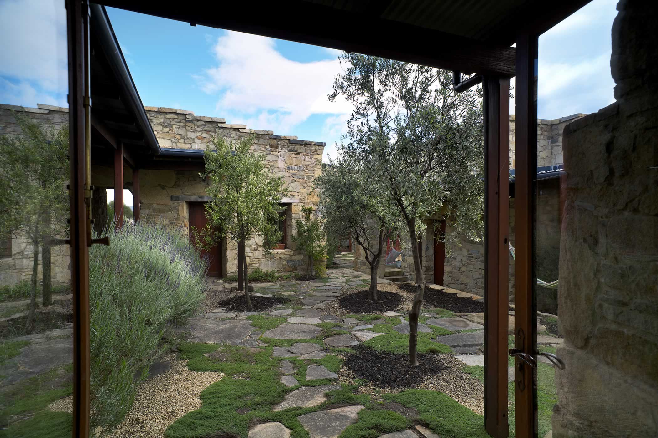 Thalia Haven, east coast Tasmania: Quiet interiors open to a central olive treed and thyme-planted courtyard which provides refuge from the often wild elements, an inward focus and an intimate scale. Photo by Ray Joyce.