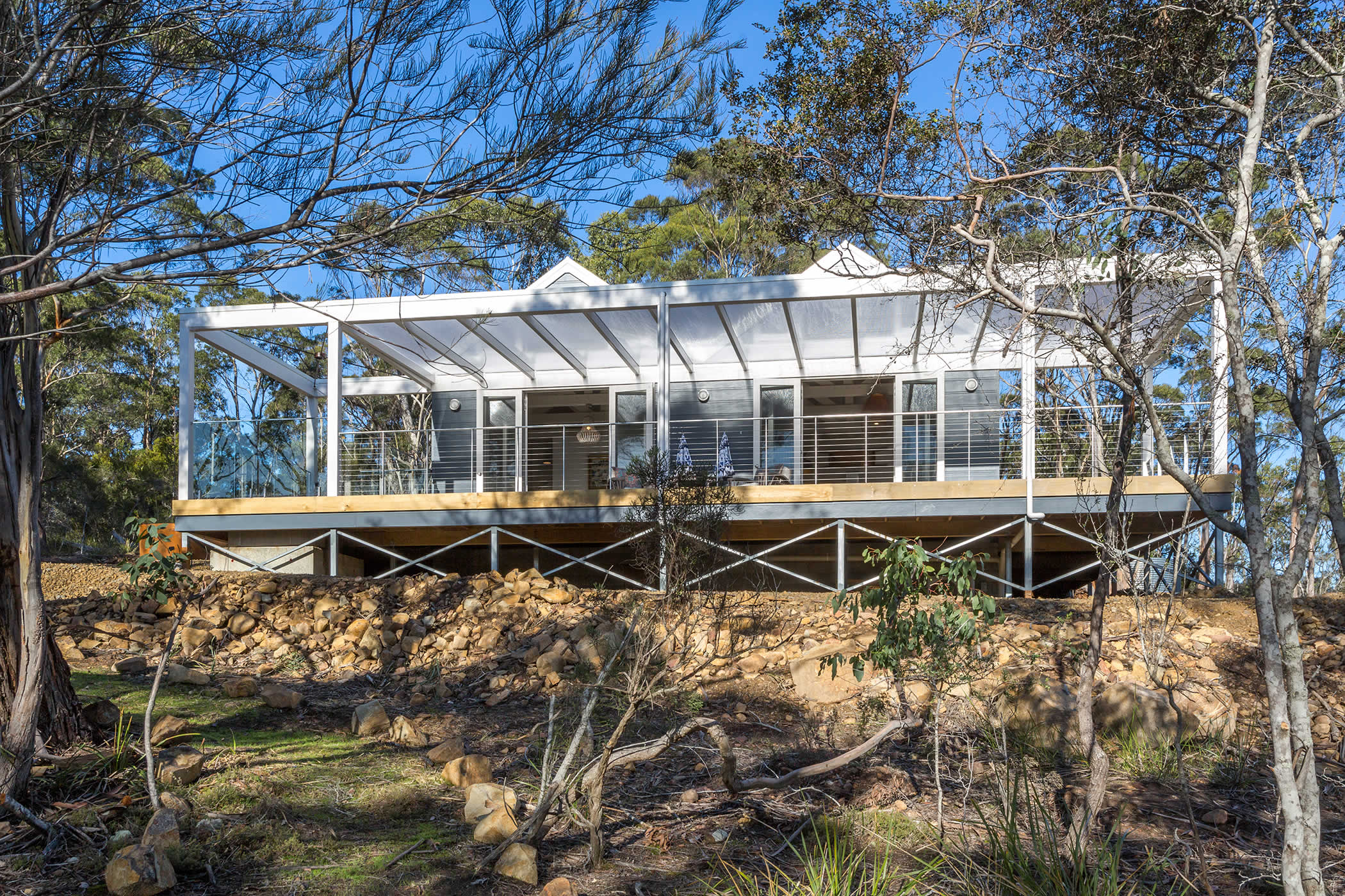 The Boat House, Blubber Head, Tasmania: The private luxury accommodation captures near and distant bush and water views, ample sun and natural light, and a covered deck provides shelter for seamless indoor / outdoor holiday living. Photo by Open2View.