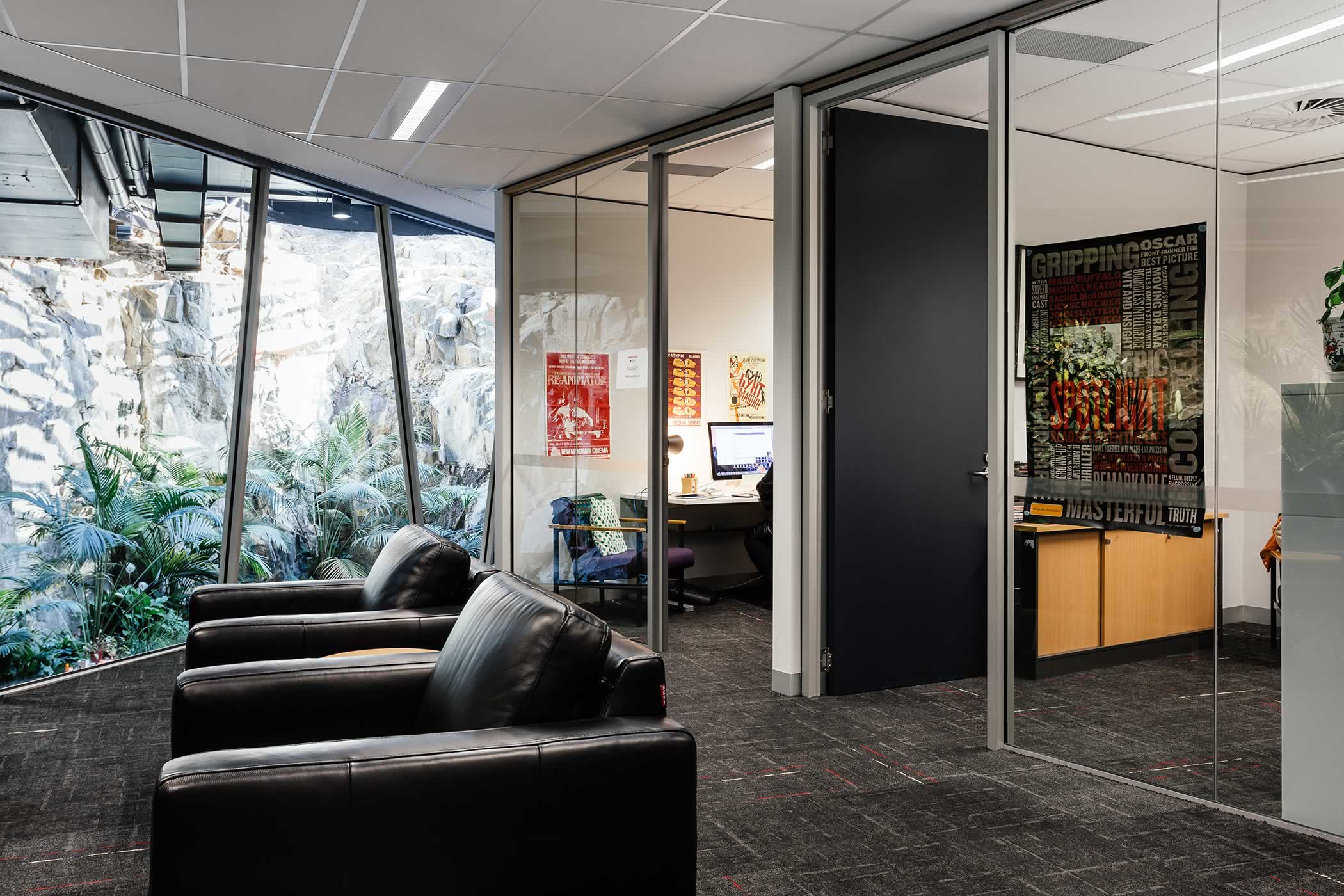 The Media School – University of Tasmania: Staff offices are positioned away from existing glazed edges with shared preparation and social space facing borrowed quarry views and natural light. Photo by Adam Gibson.